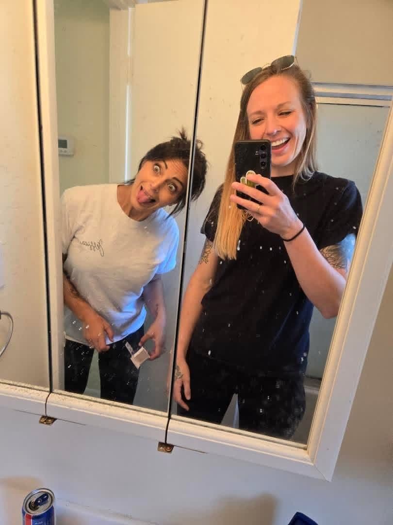 Jessica and Kate mid-clean, caught in a mirror